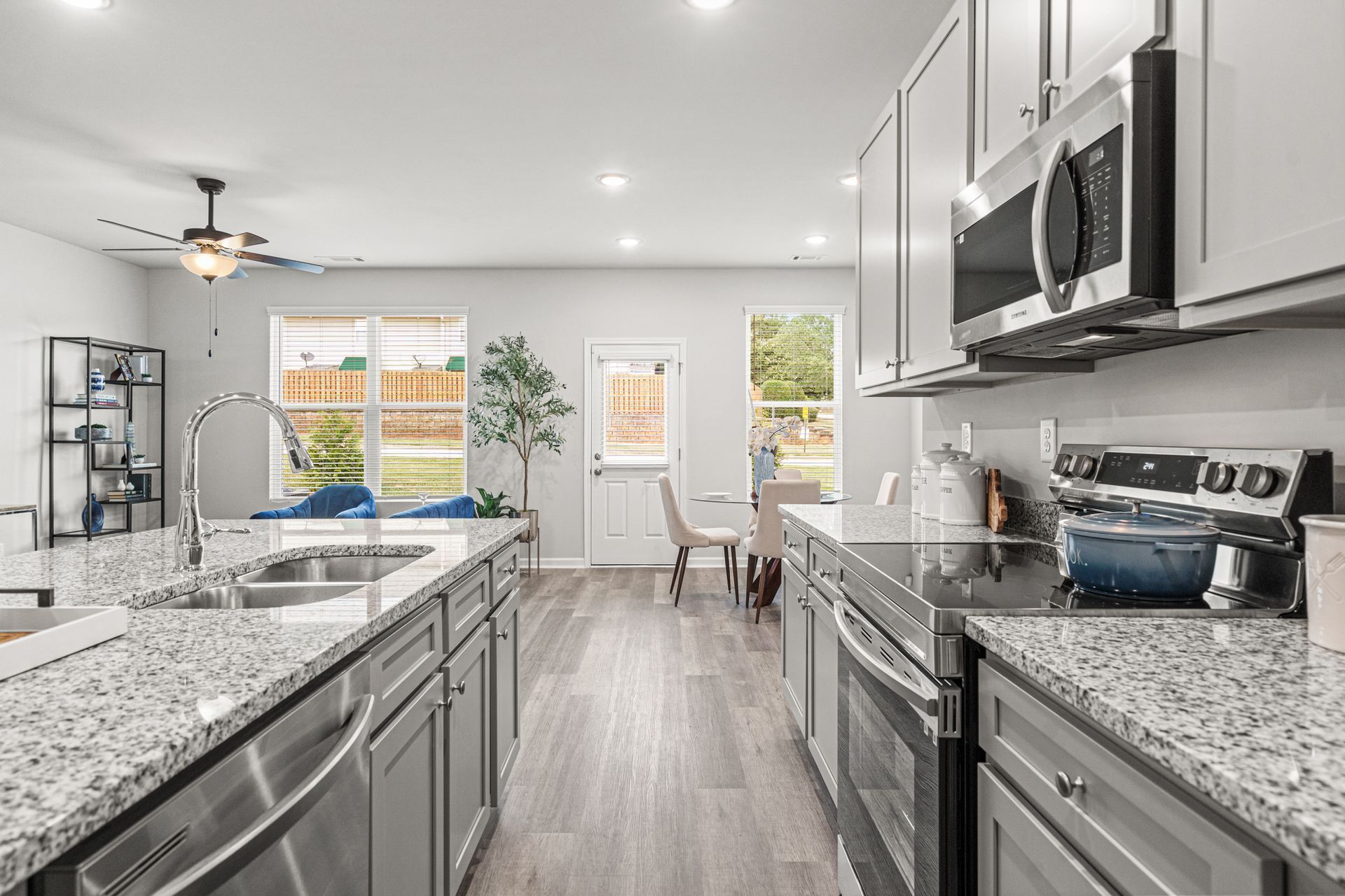 A kitchen with granite counter tops and stainless steel appliances.