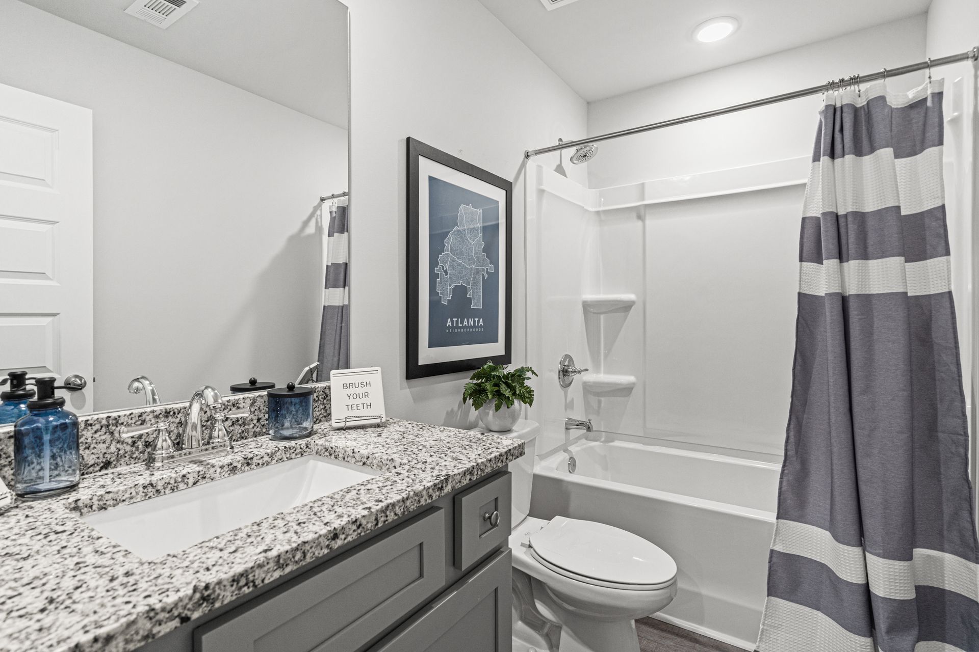 A bathroom with a sink , toilet , bathtub and mirror.