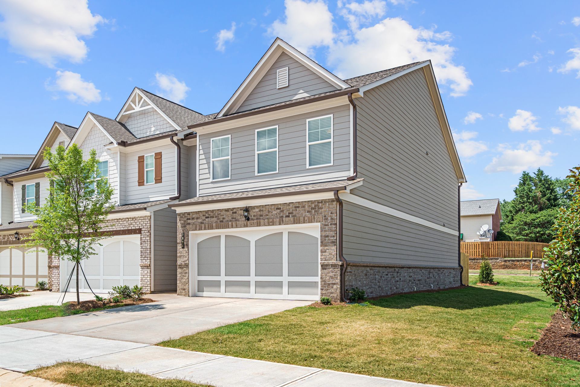 A large house with a lot of windows and a large garage.