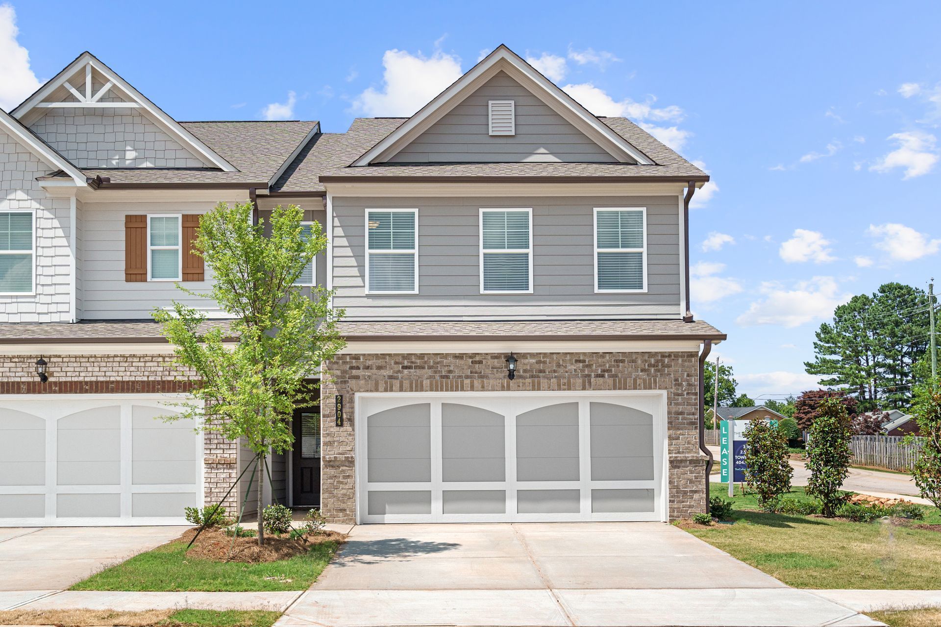 A large house with a lot of windows and a large garage.