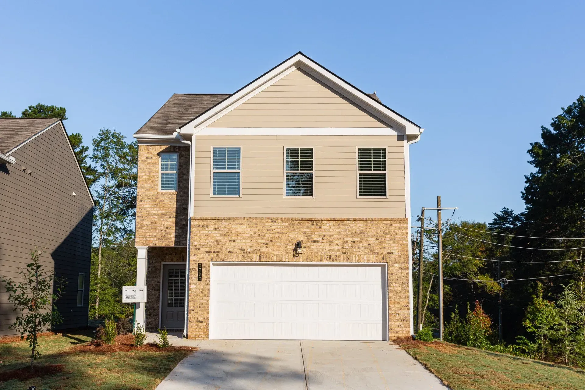 The front of a house with a white garage door