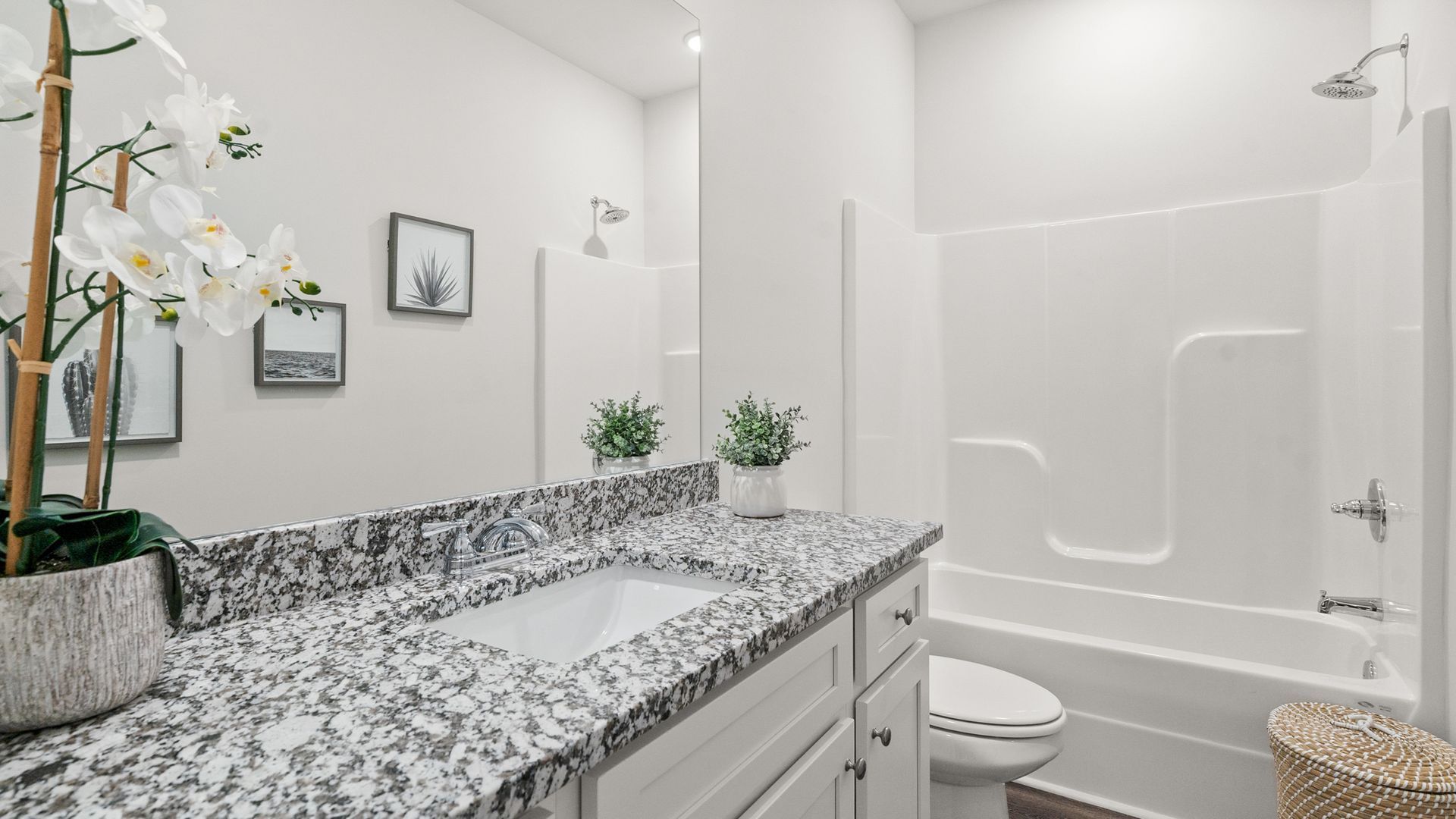 A bathroom with a sink , toilet , bathtub and shower.