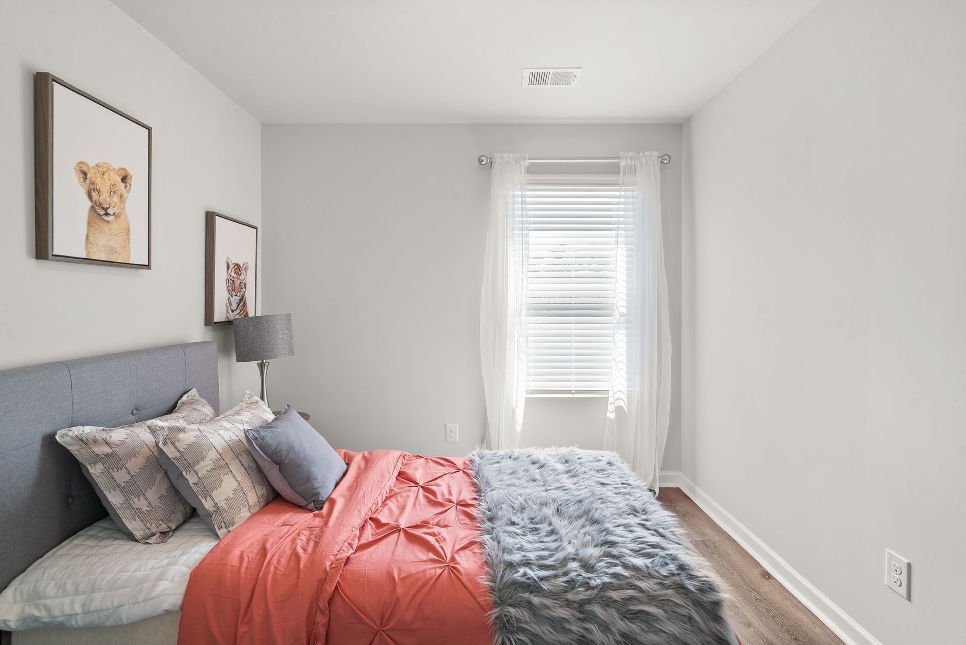 A bedroom with a large bed and a window.