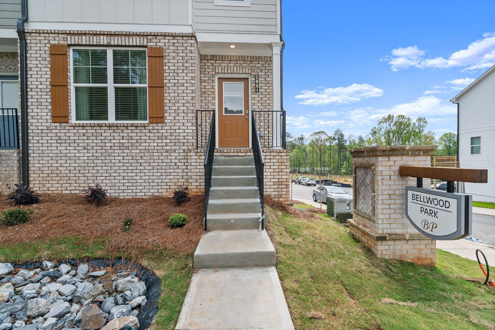 A brick house with stairs leading up to the front door.