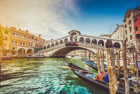 Gondolas resting in a silent canal—experience the timeless charm of Venice