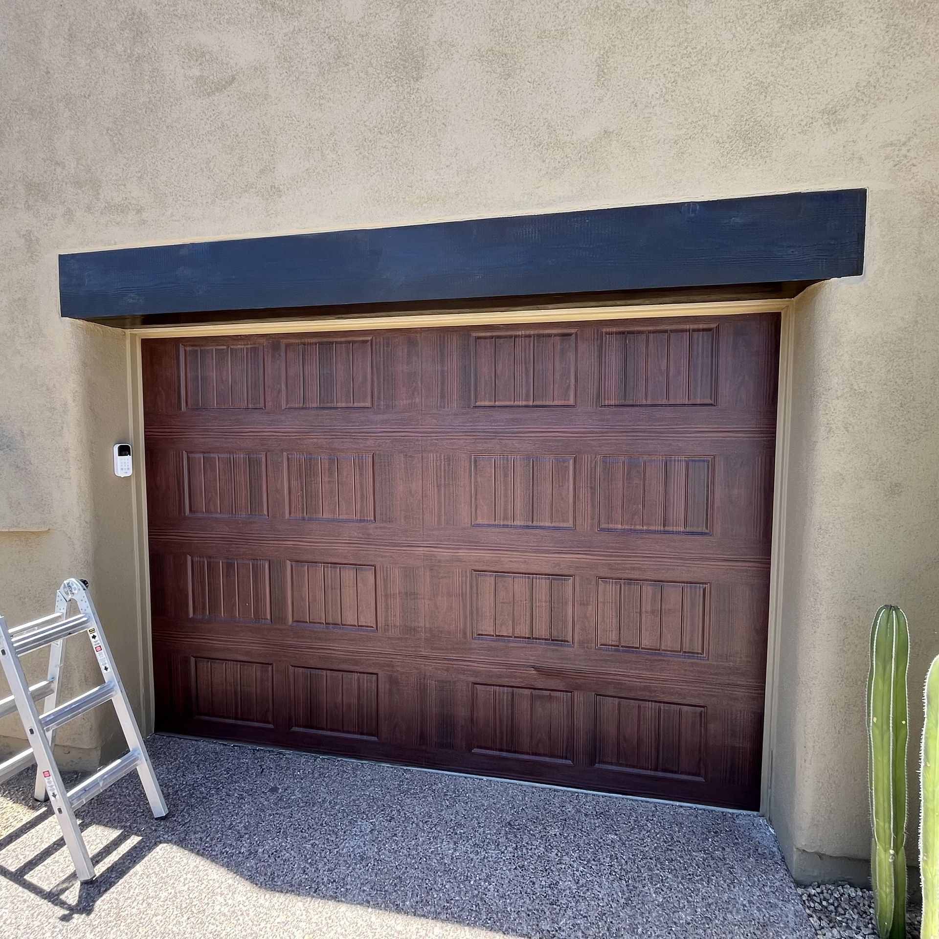 A wooden garage door with a ladder in front of it
