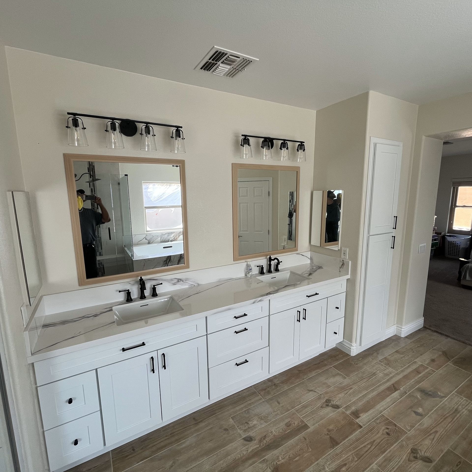 A bathroom with two sinks and two mirrors.
