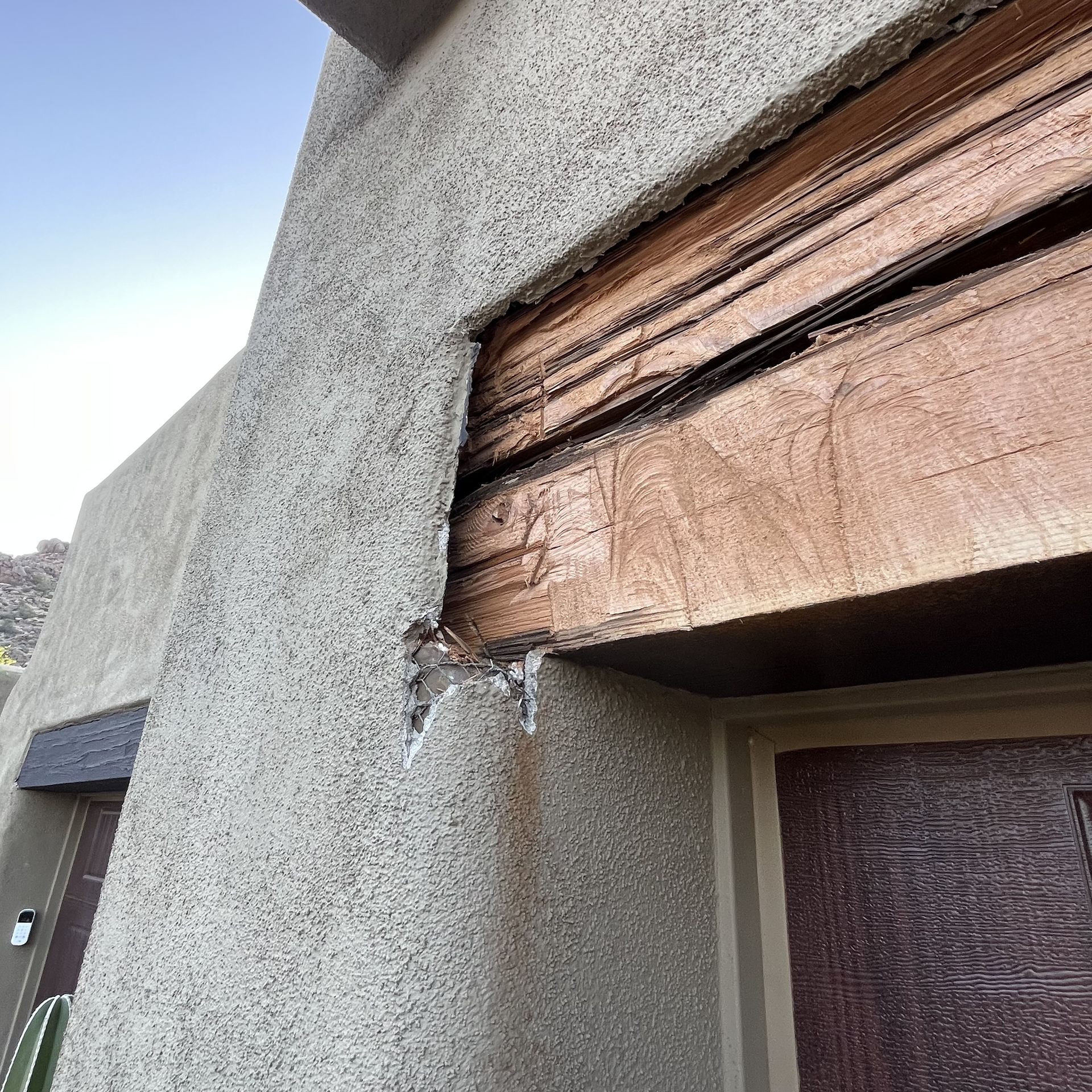A close up of a wooden beam on the side of a building.