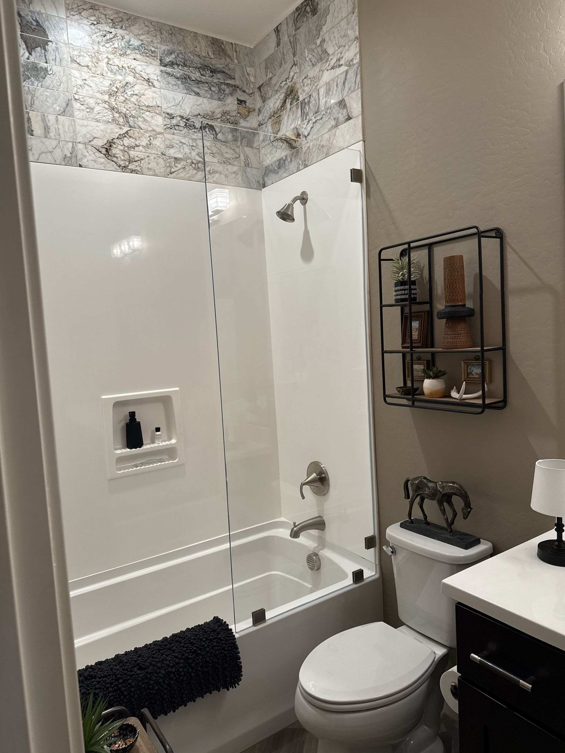 A bathroom with a tub , toilet , sink and shower.