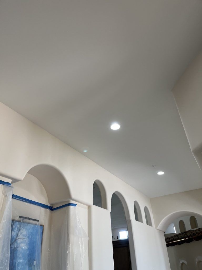 A room with white walls and arches and a white ceiling.