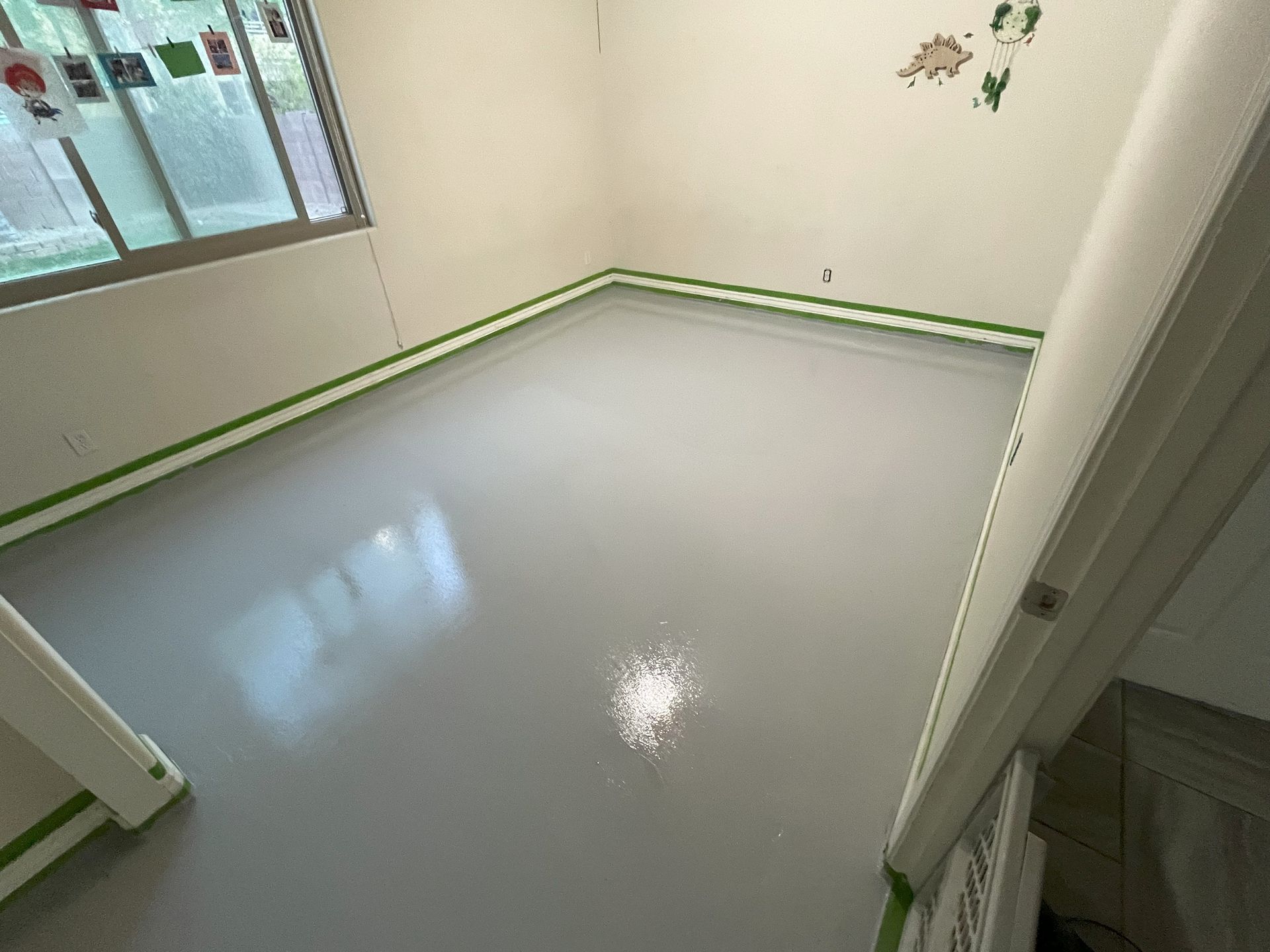 A room with a gray floor and white walls.