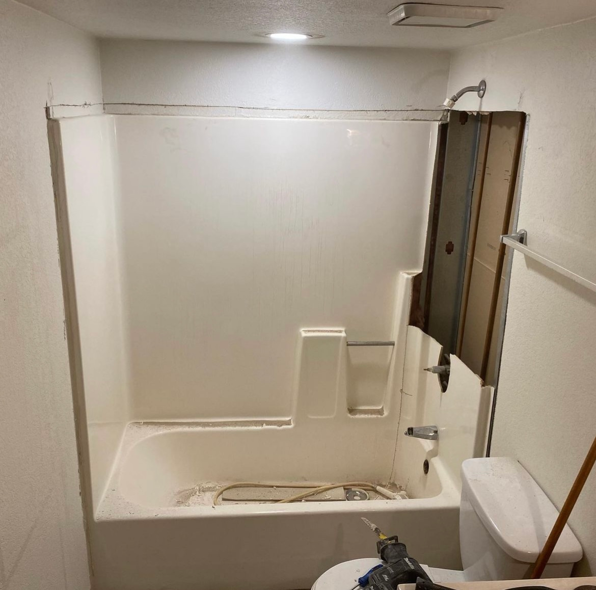 A bathroom with a bathtub and a toilet