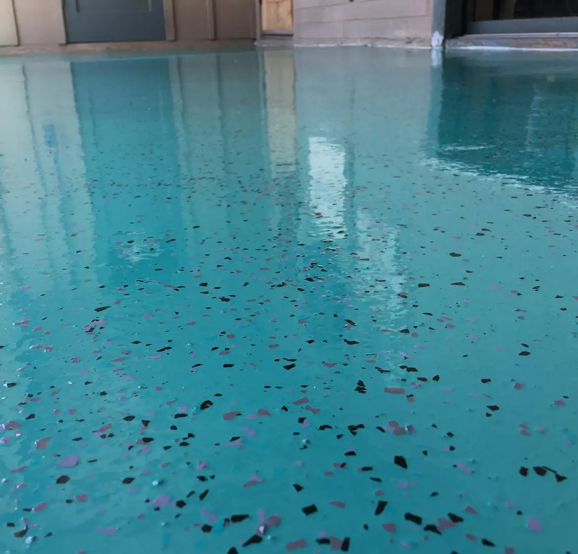 A swimming pool with a lot of confetti on the floor.