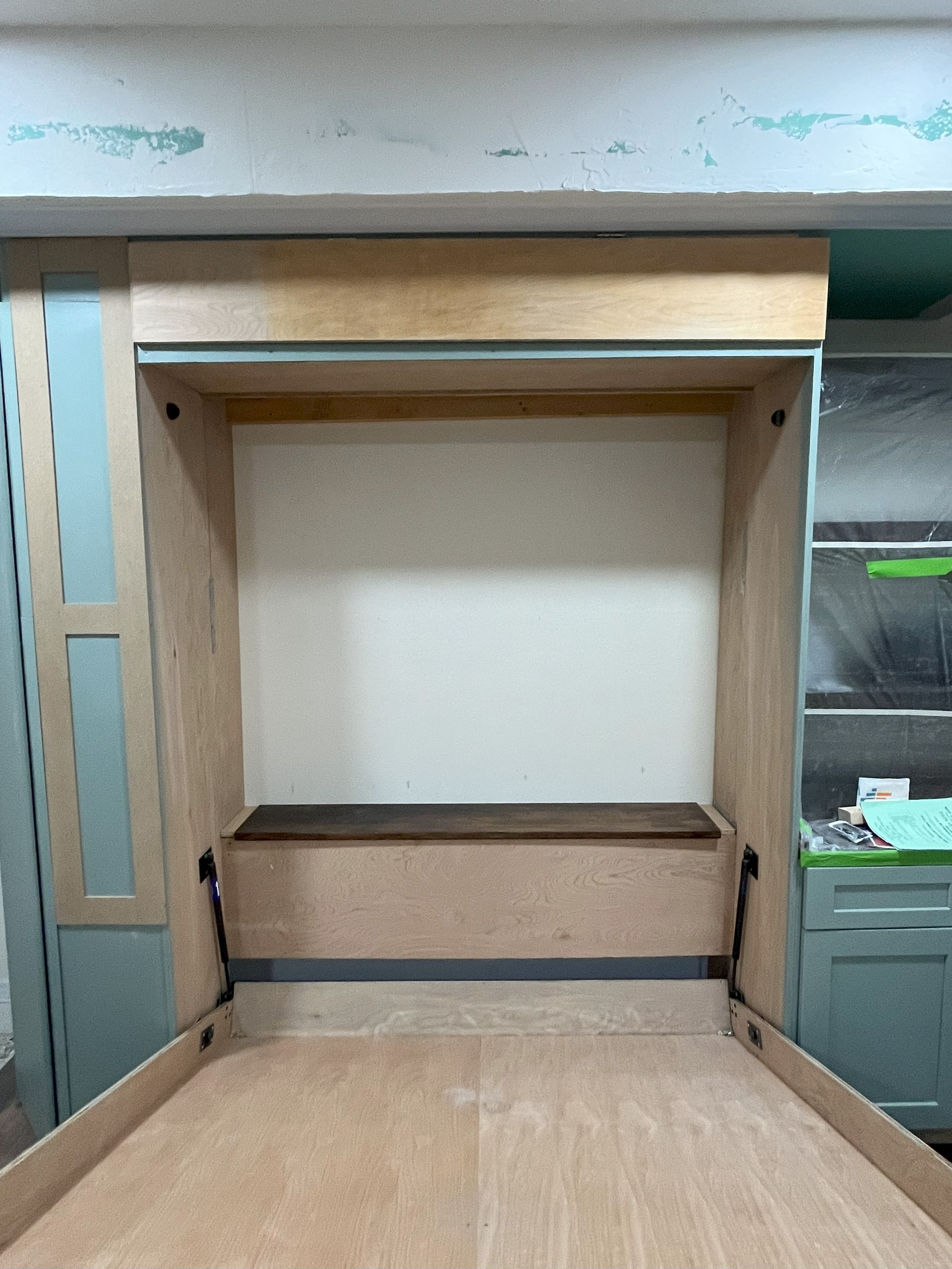 A room with a wooden bench in the middle of it.