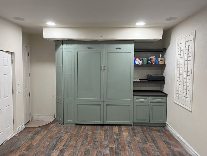 A room with a lot of cabinets and a wooden floor