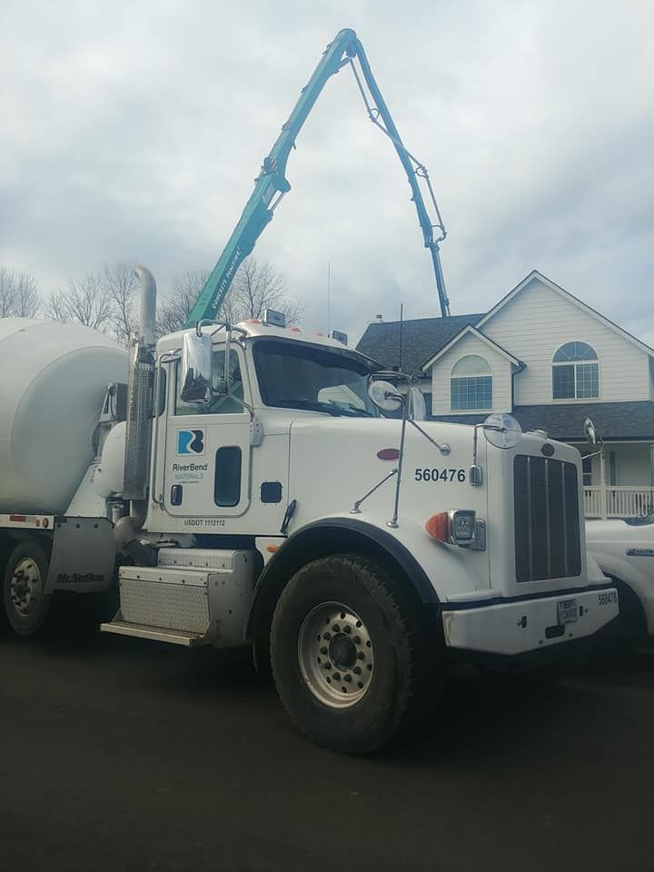 A white kenworth truck is parked in front of a house