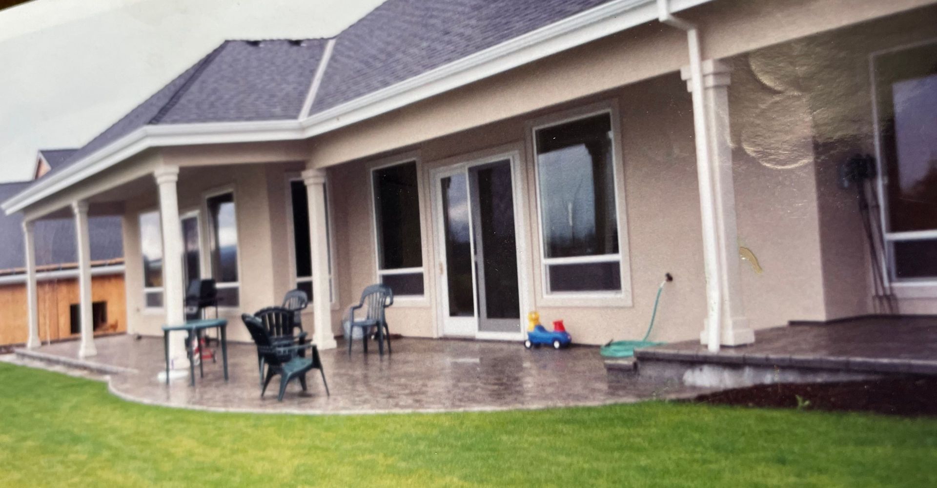 A large house with a patio in front of it