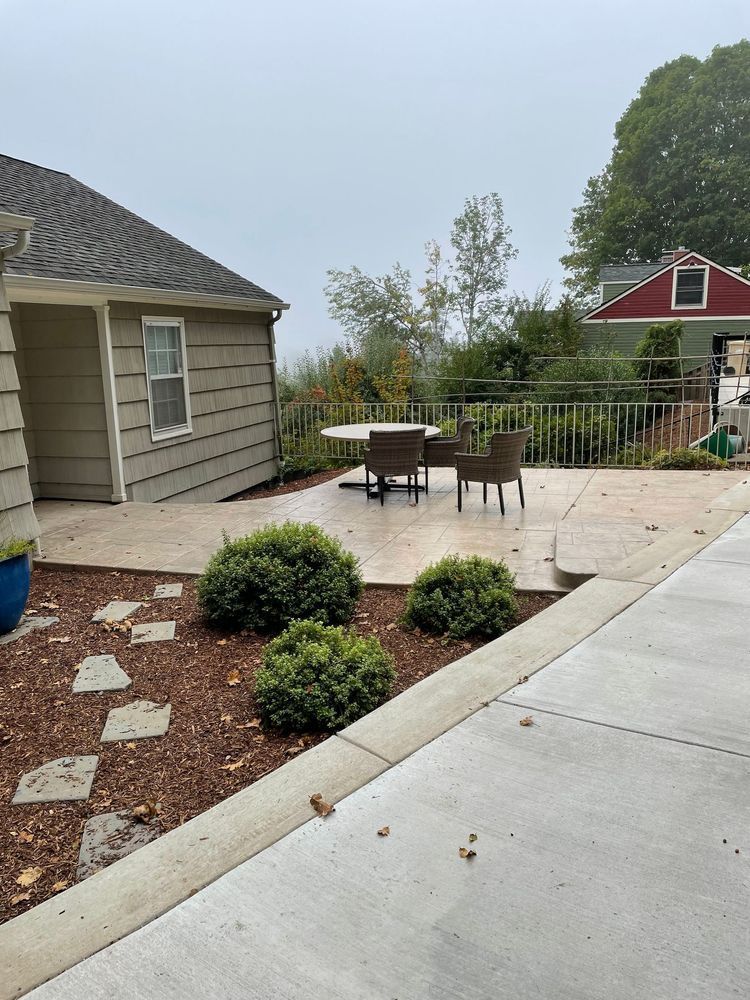 A patio with a table and chairs in front of a house.