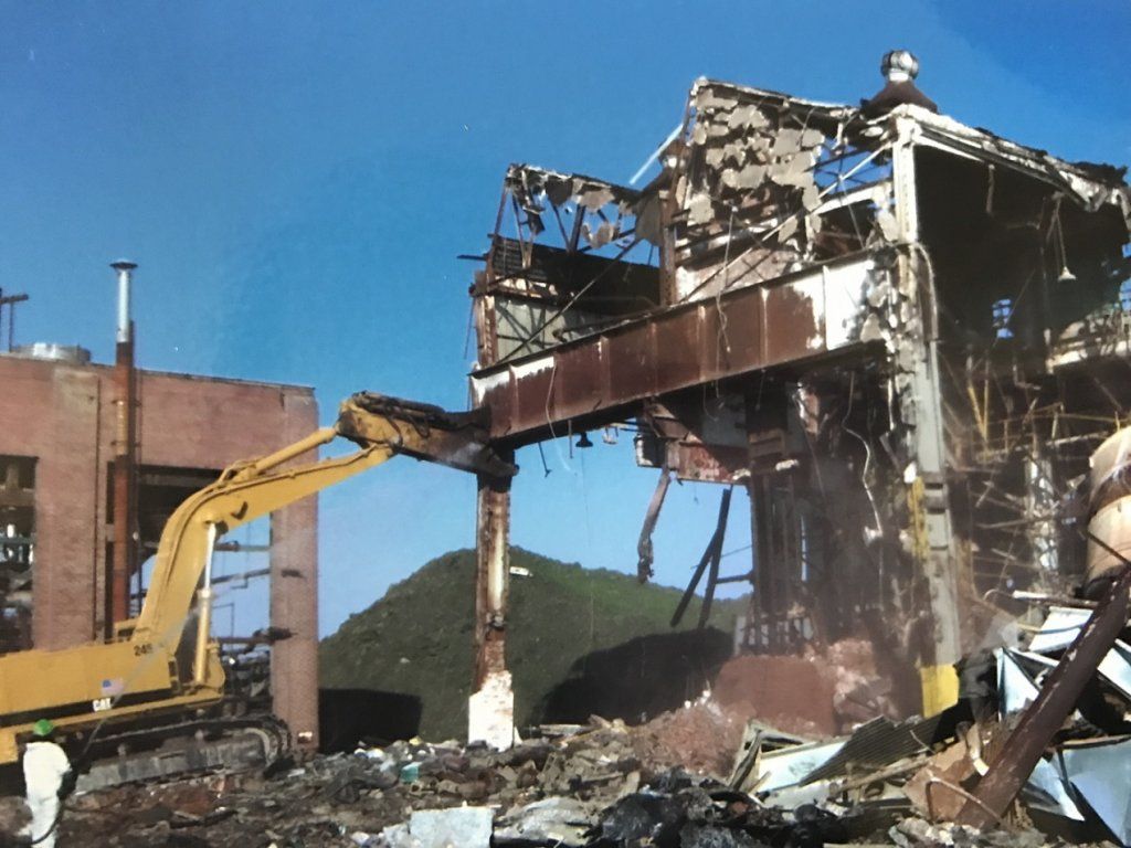Excavator tearing down metal frame building — Demolition in Sewell, NJ