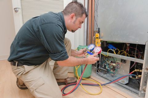 HVAC Technician Working — Heating & Air-Conditioning Services in Avalon, NJ