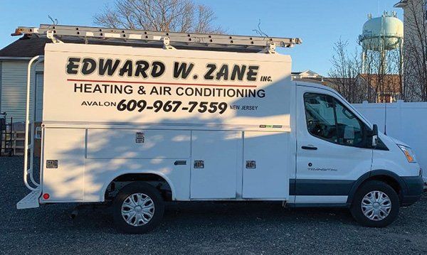 Owners with Car Service — Heating and Air- Conditioning Service in Avalon, NJ