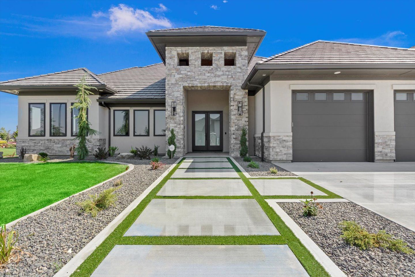 A large house with a concrete driveway leading to it.