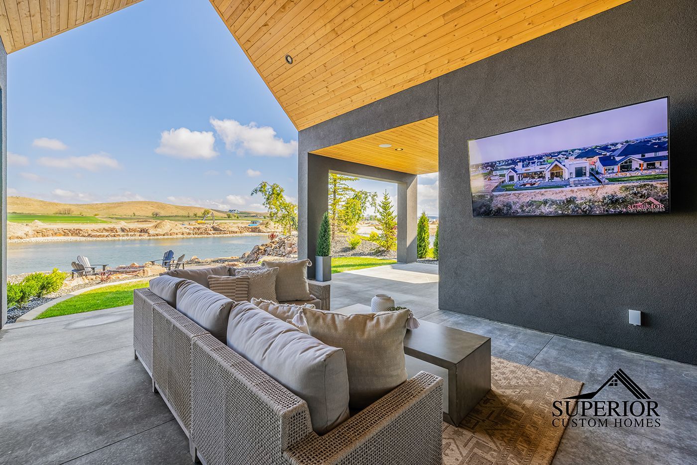 A living room with a couch and a television on the wall.