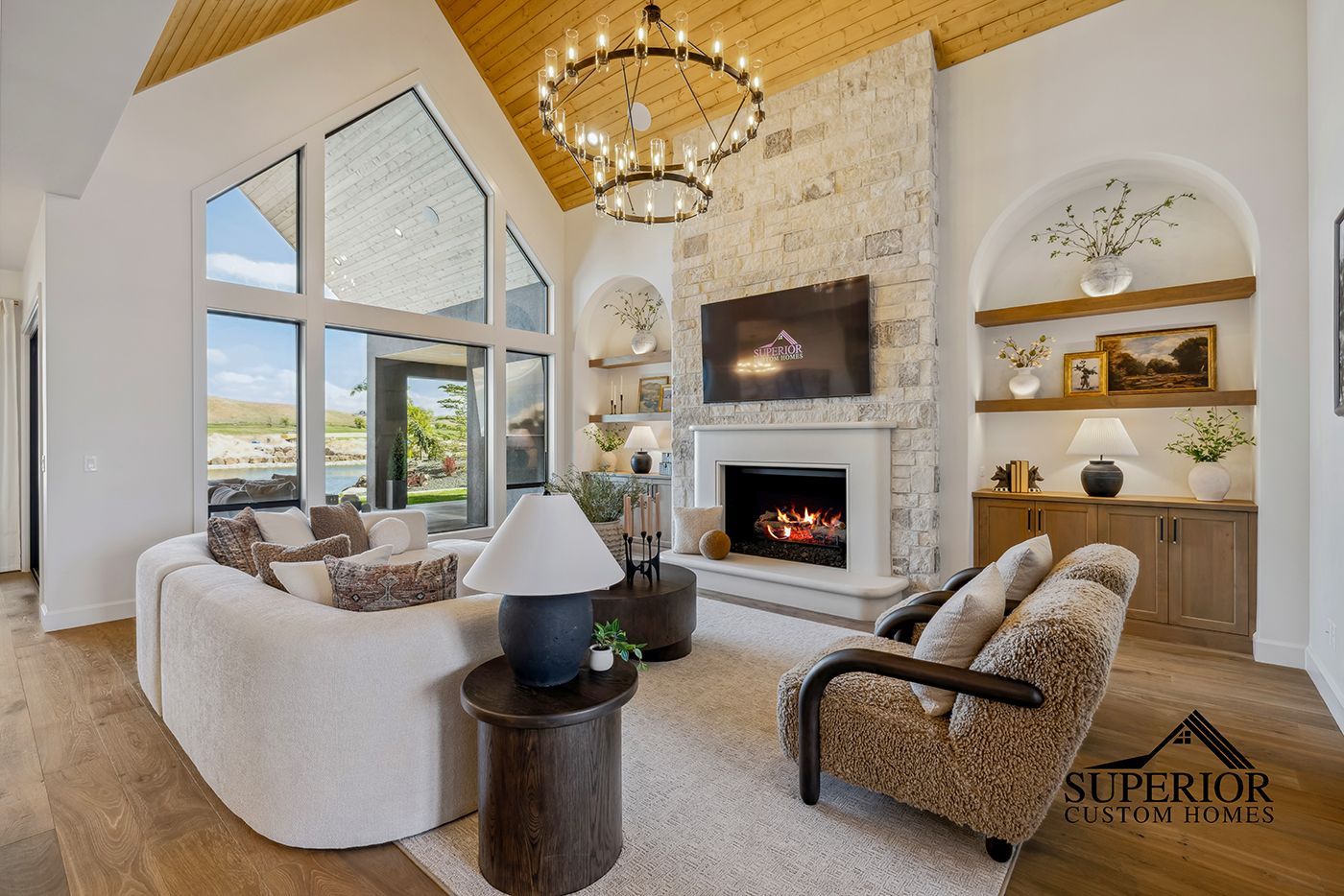 A living room with a fireplace , couch , chair and television.
