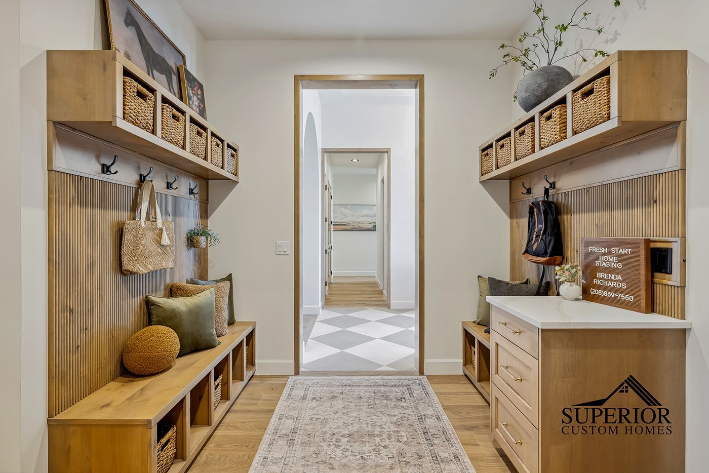 A hallway with a bench and a dresser in a house.