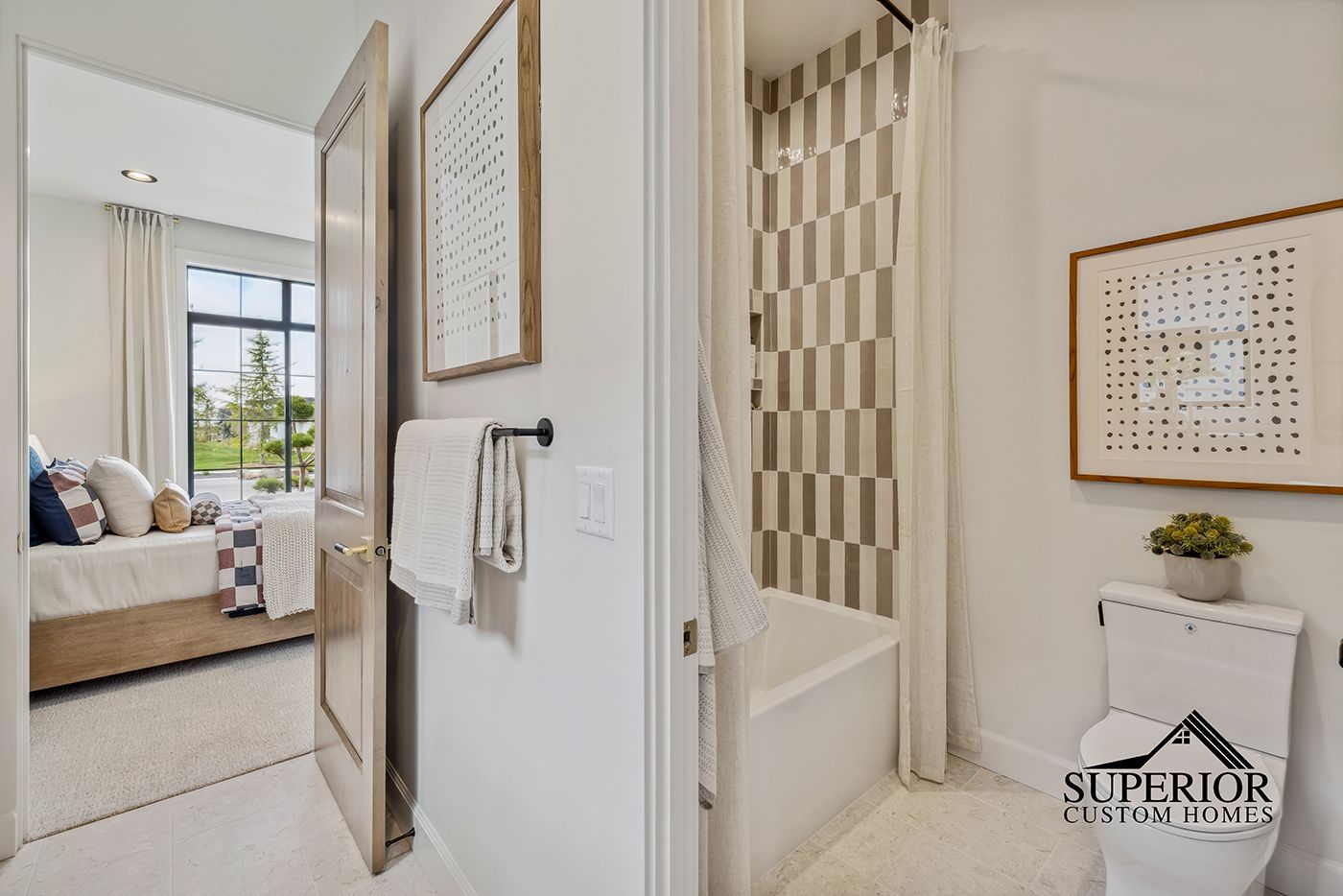 A bathroom with a toilet , bathtub , and mirrors.