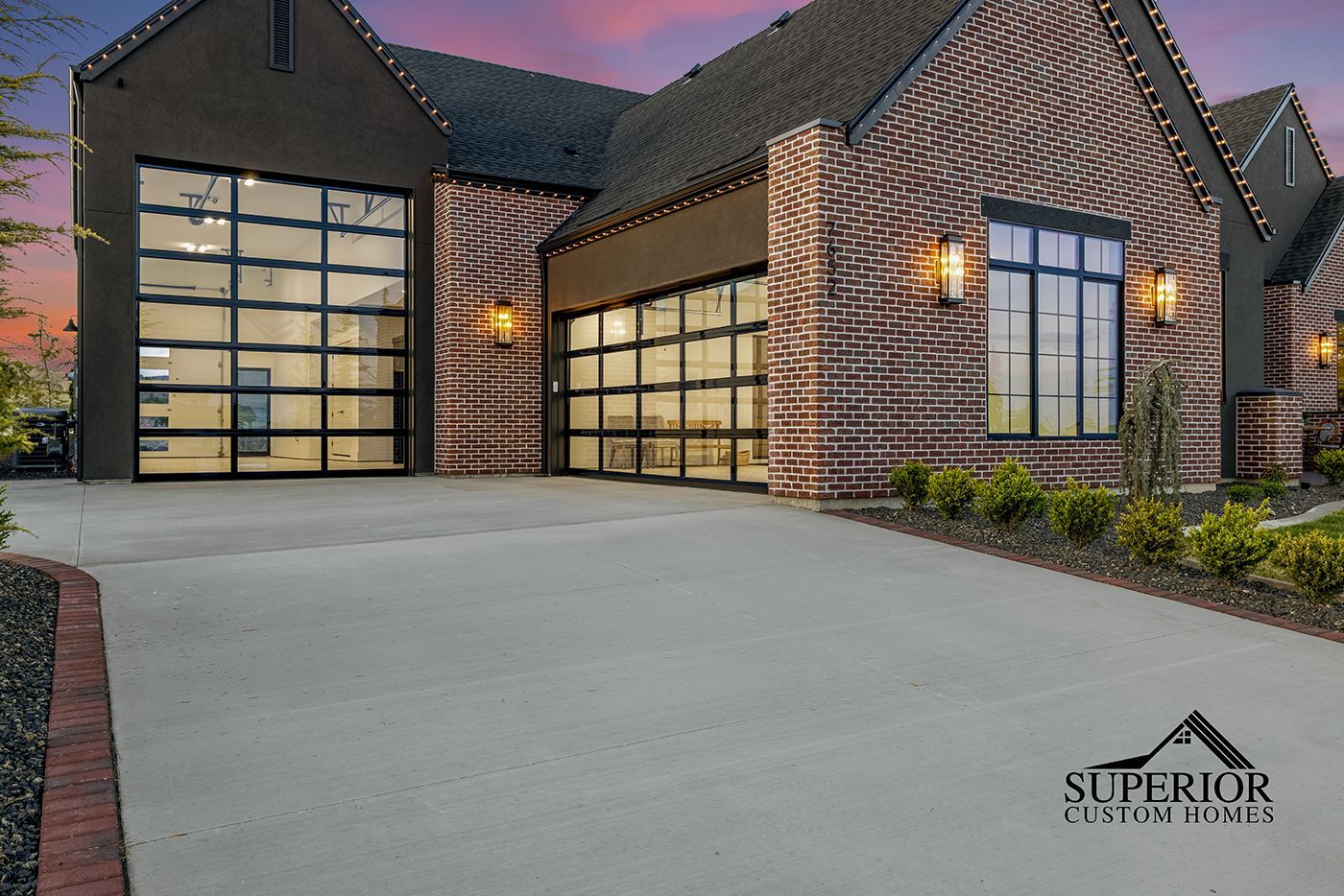 A large brick house with a large garage door.