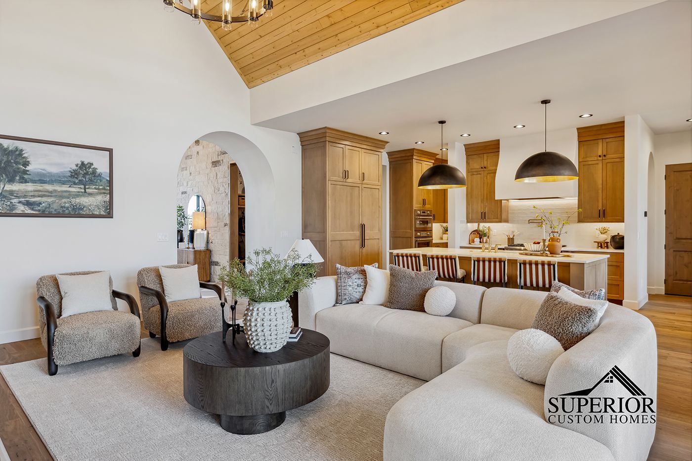 A living room with a couch , chairs , and a coffee table.