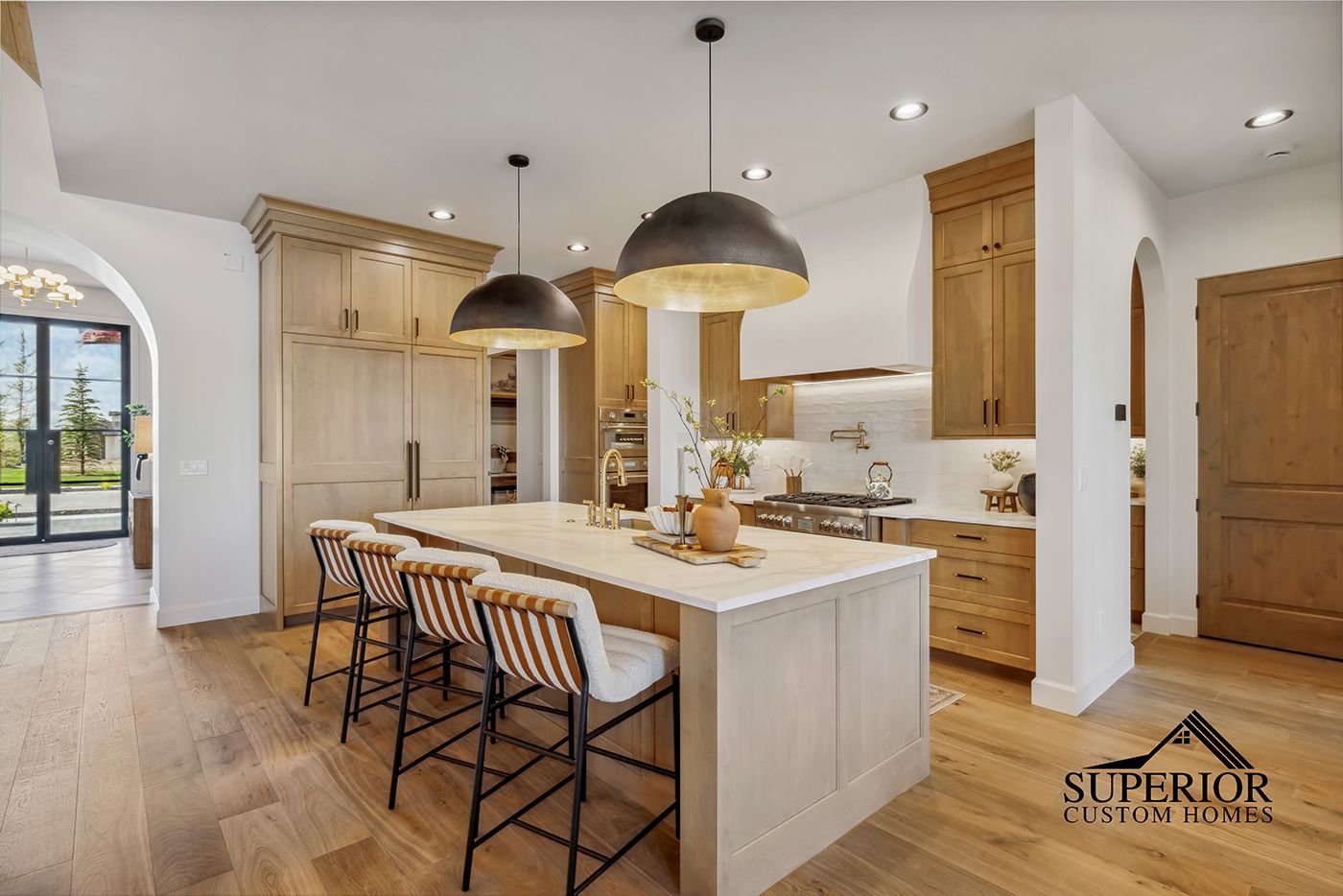 A kitchen with wooden cabinets and a large island.