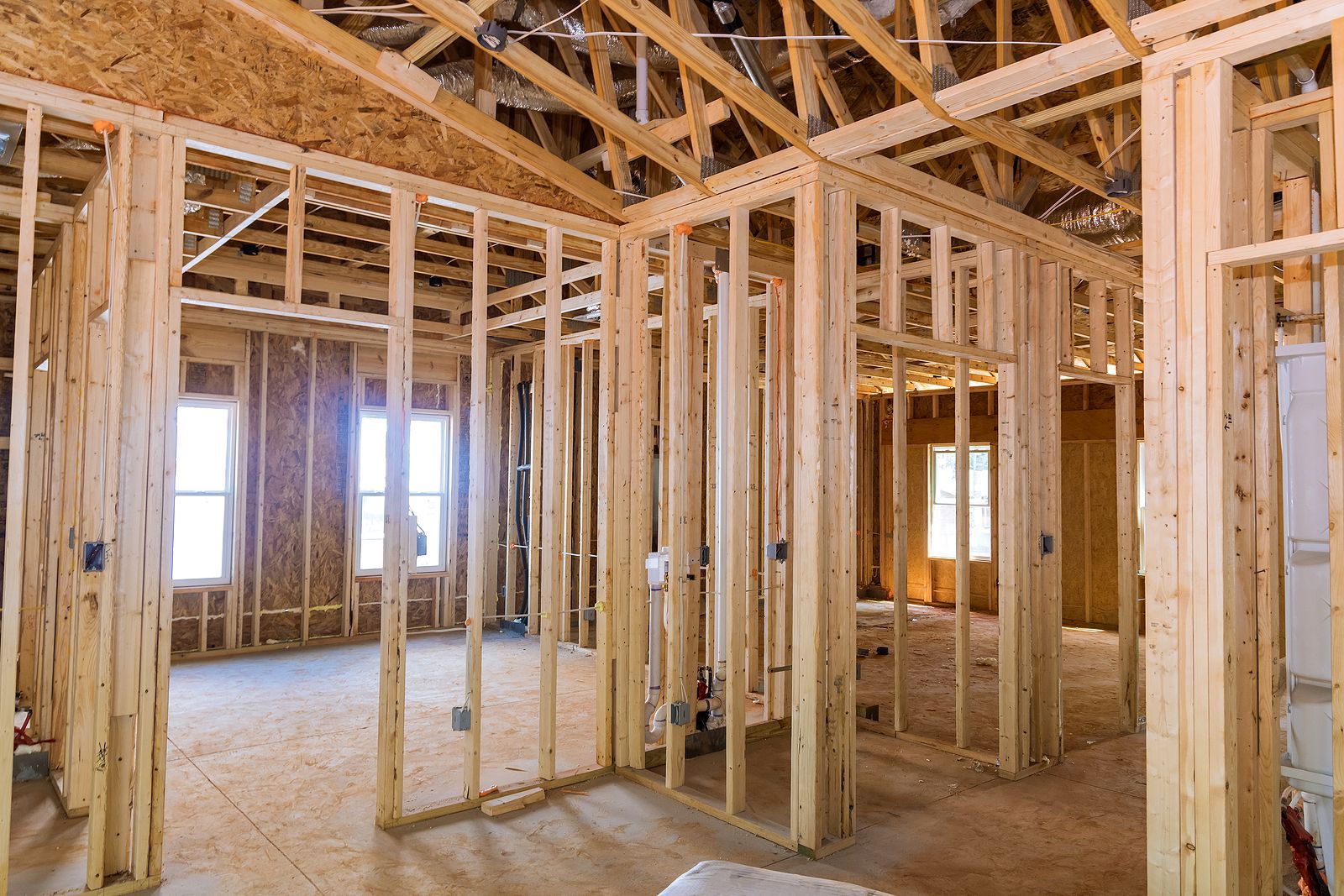 The inside of a house under construction with wooden beams.