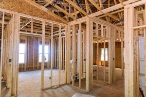 The inside of a house under construction with wooden beams.