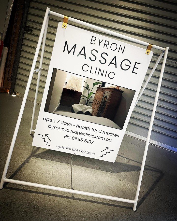 A Sign for Byron Massage Clinic is Sitting on the Ground — Sign Media Solutions in Ballina, NSW