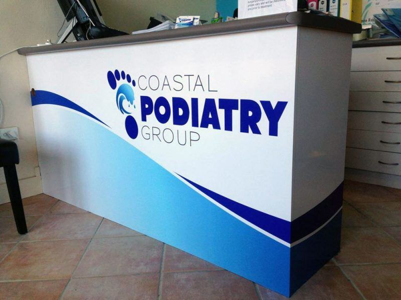 A Coastal Podiatry Group Sign on a Counter — Sign Media Solutions in Ballina, NSW