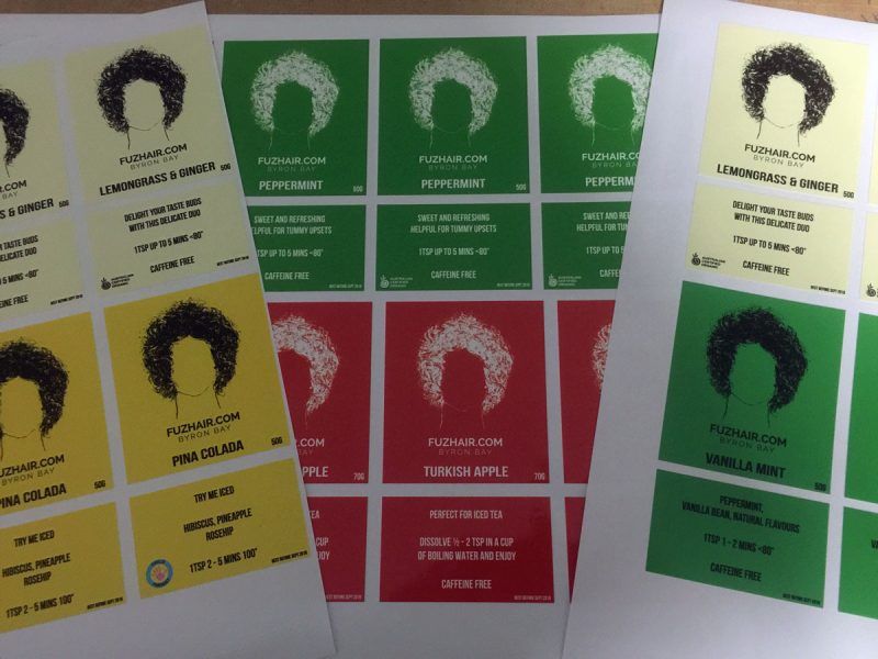 A Bunch of Different Colored Labels on a Table — Sign Media Solutions in Ballina, NSW