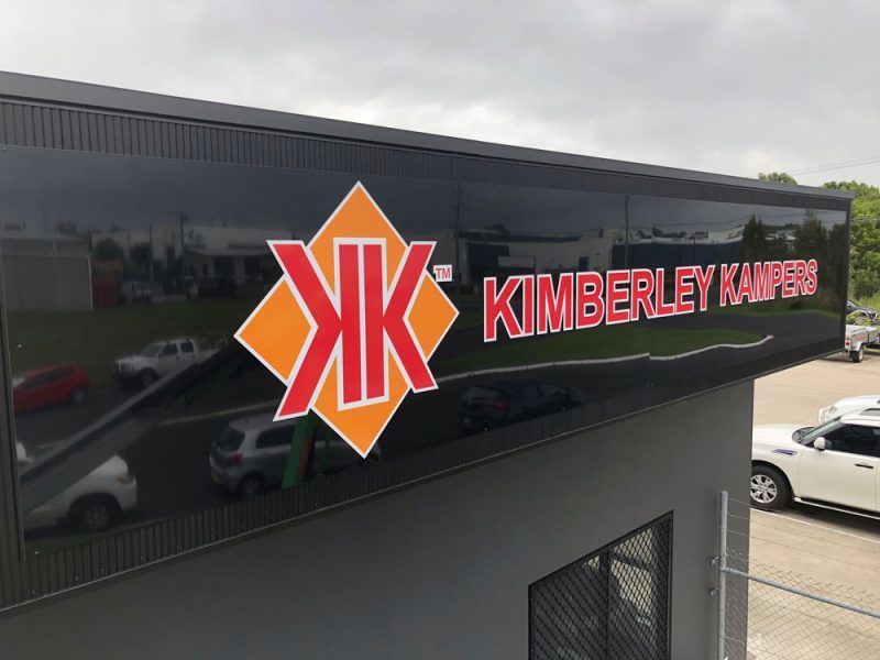 A Sign on the Side of a Building That Says Kimberley Kampers — Sign Media Solutions in Ballina, NSW