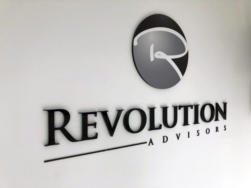 A Revolution Advisors Sign on a White Wall — Sign Media Solutions in Ballina, NSW