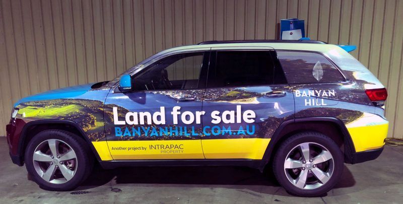 A Blue and Yellow Suv With the Words Land for Sale on the Side — Sign Media Solutions in Ballina, NSW