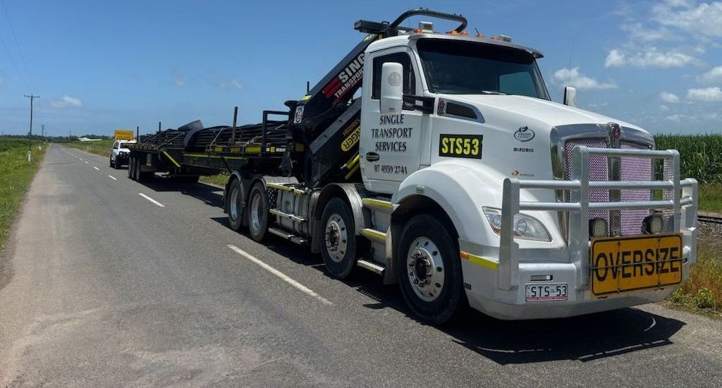 A large white truck is driving down a road — Single Transport Services In Palmyra, QLD