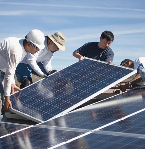 Men Installing the Solar Panel on Rooftop — Denver, CO — J&P Roofing Inc.