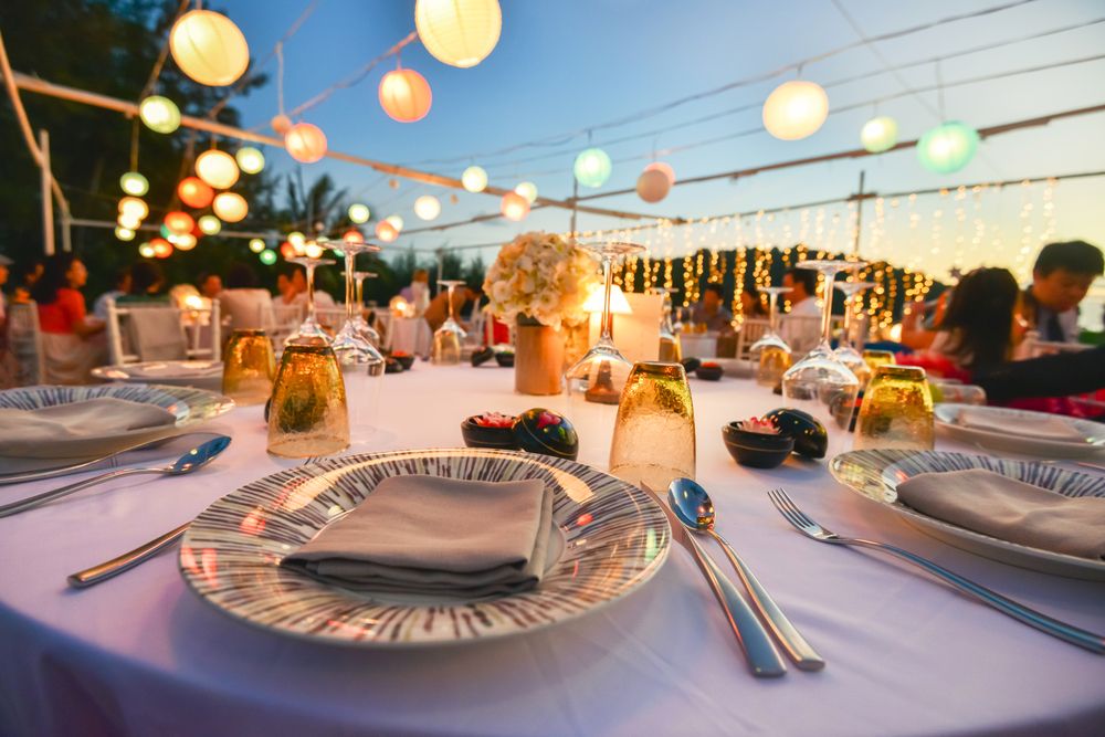 A Table Set for a Wedding Reception With Plates , Glasses , and Silverware — Bowen Hire & Sales in Bowen, QLD