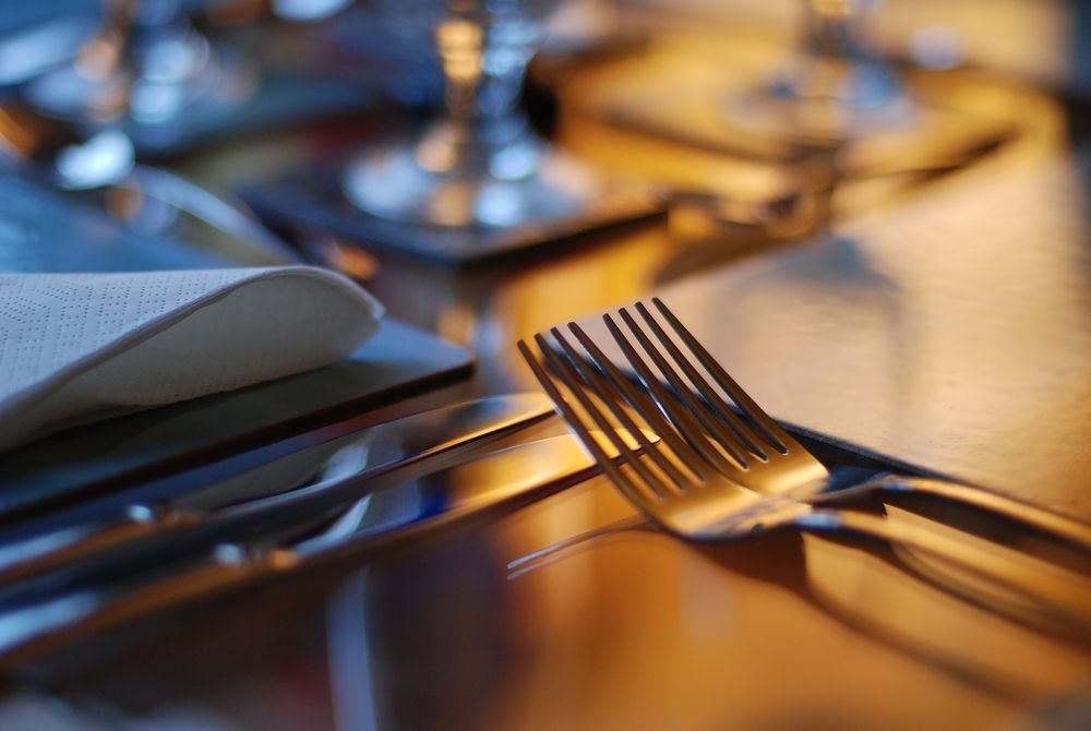 A Close Up of Silverware on a Table With a Napkin — Bowen Hire & Sales in Bowen, QLD