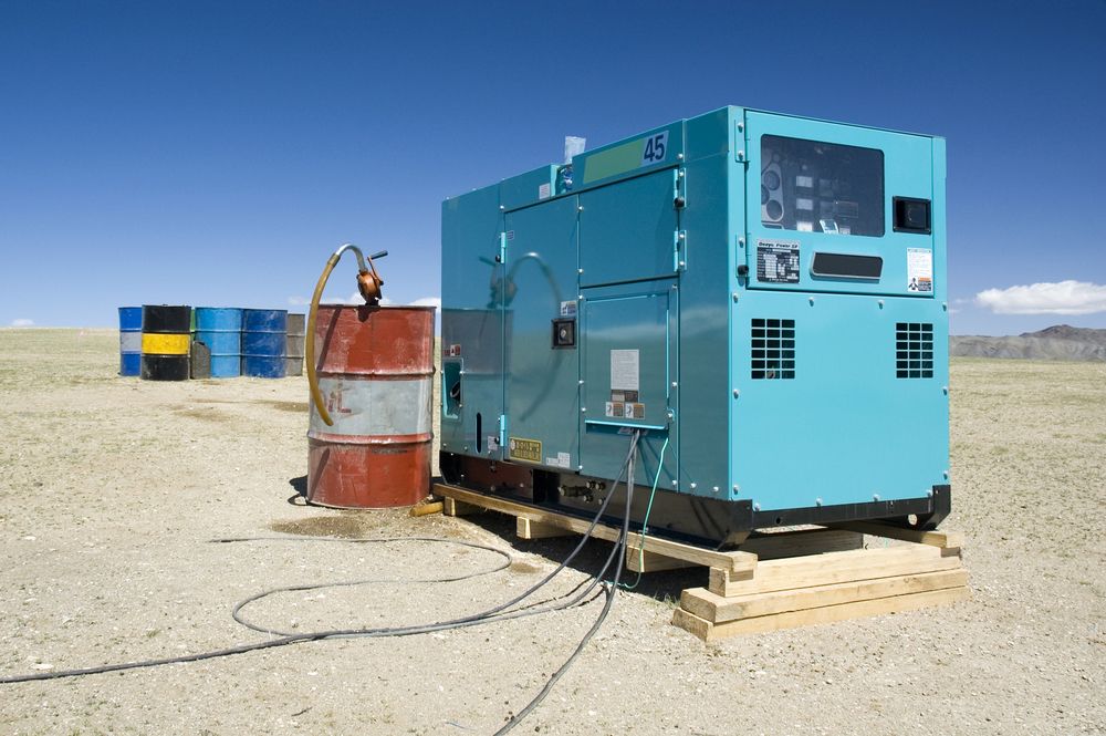 A Blue Generator is Sitting on a Wooden Pallet in the Middle of a Desert — Bowen Hire & Sales in Airlie Beach, QLD