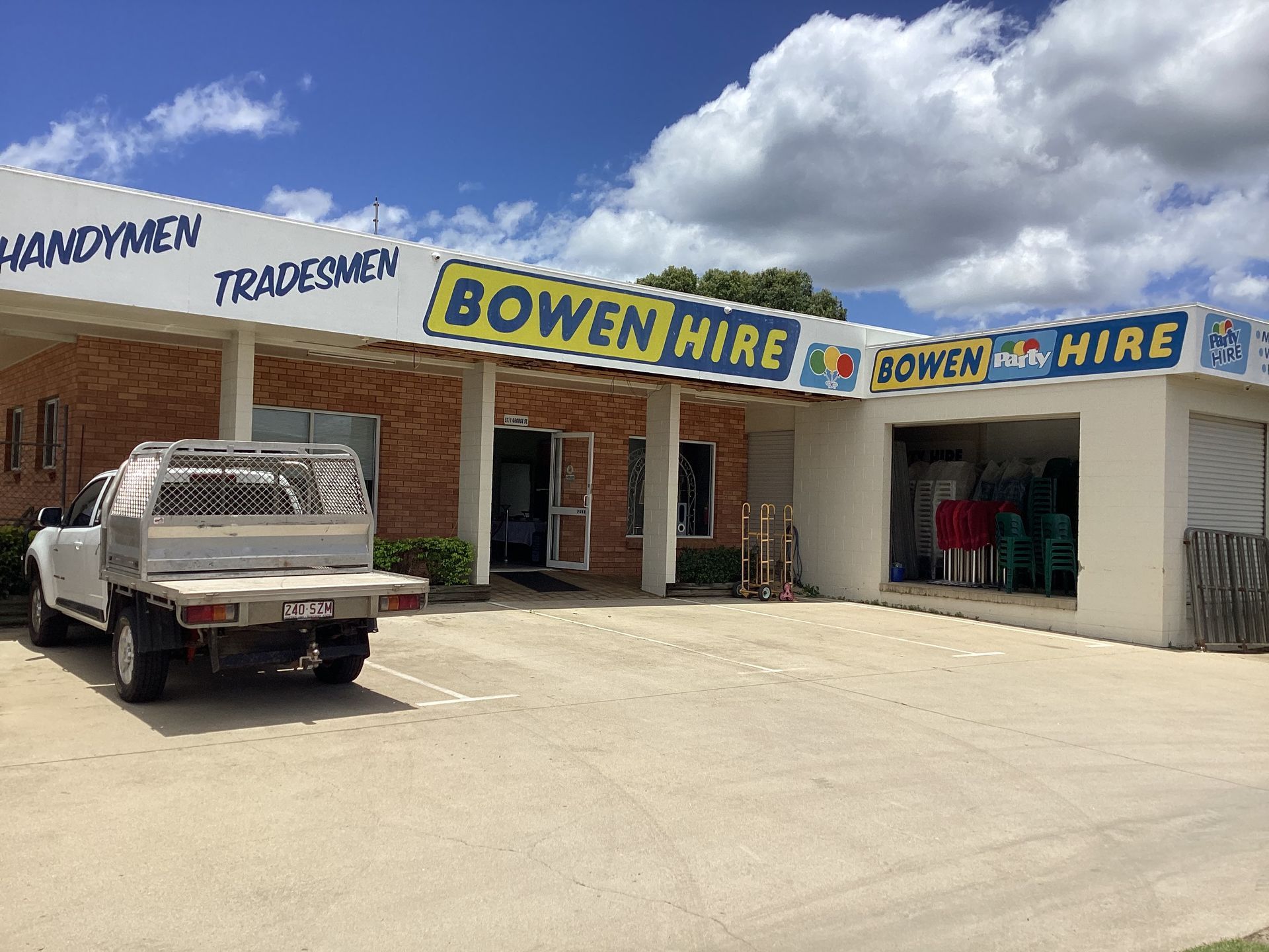 A White Truck is Parked in Front of a Building That Says Bowen Hire — Bowen Hire & Sales in Bowen, QLD