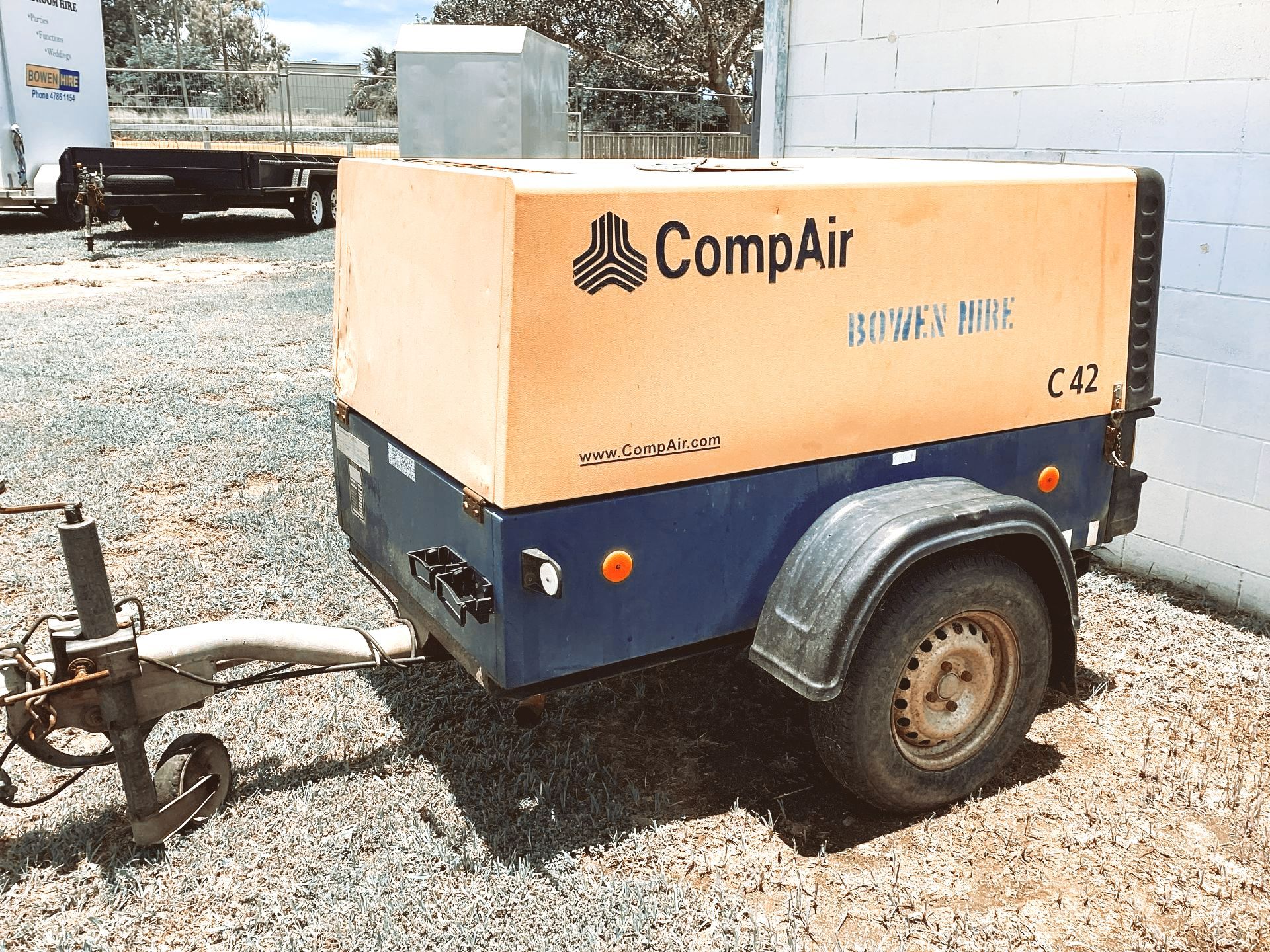 A Blue and Yellow Compair Air Compressor on a Trailer — Bowen Hire & Sales in Bowen, QLD