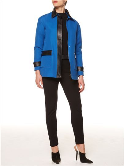 A woman is wearing a blue jacket and black pants