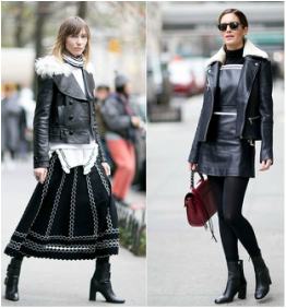 Two women are walking down the street wearing leather jackets and skirts